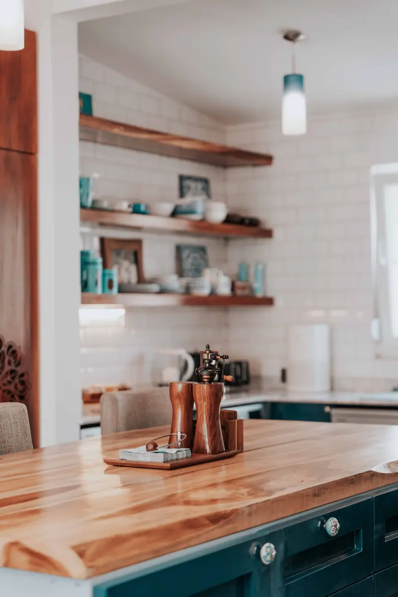 Butcher block countertop on a dark green island