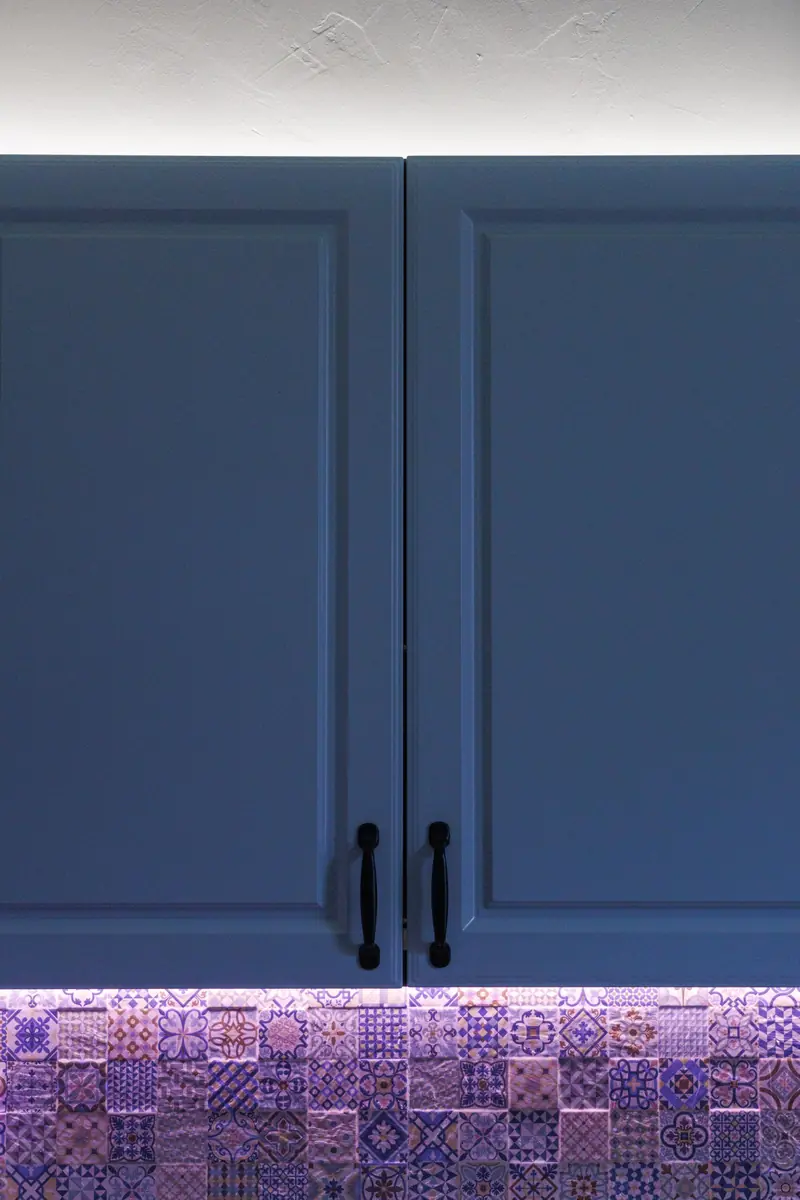 Navy raised-panel cabinet doors with black pulls
