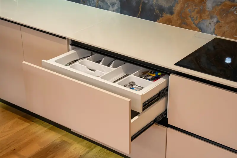 Open kitchen drawer with a fitted cutlery organizer